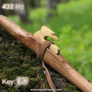 May include: A wooden Native American flute with a bird carving on the top. The flute is brown and has a natural wood finish. The text "432 Hz" and "Key: F#" is visible on the image.