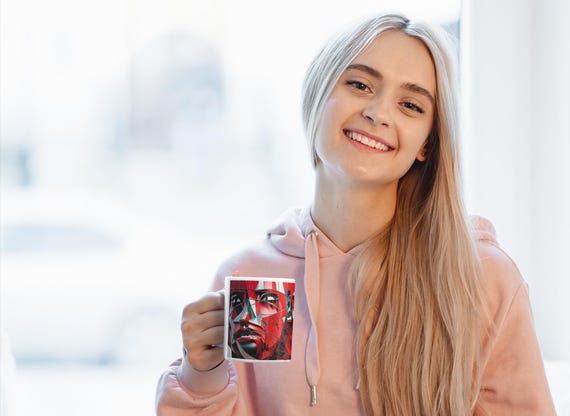 Abstract coffee mug with geometric face motif in red and black