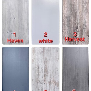 May include: Six different wood-look laminate samples, labeled 1-6. The samples are Haven, white, Harvest, Navy Blue, Barn Wood, and Charcoal.