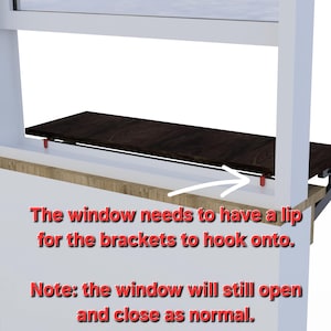 May include: A white window frame with a wooden shelf attached to the bottom. The shelf is supported by brackets that hook onto the window frame. The text "The window needs to have a lip for the brackets to hook onto. Note: the window will still open and close as normal." is written below the shelf.