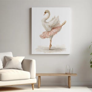 May include: A canvas print showing a watercolour painting of a swan in a ballet pose. The swan has white feathers and a pink tutu, set against a neutral background. The artwork is displayed in a living room setting, with a sofa and a plant.
