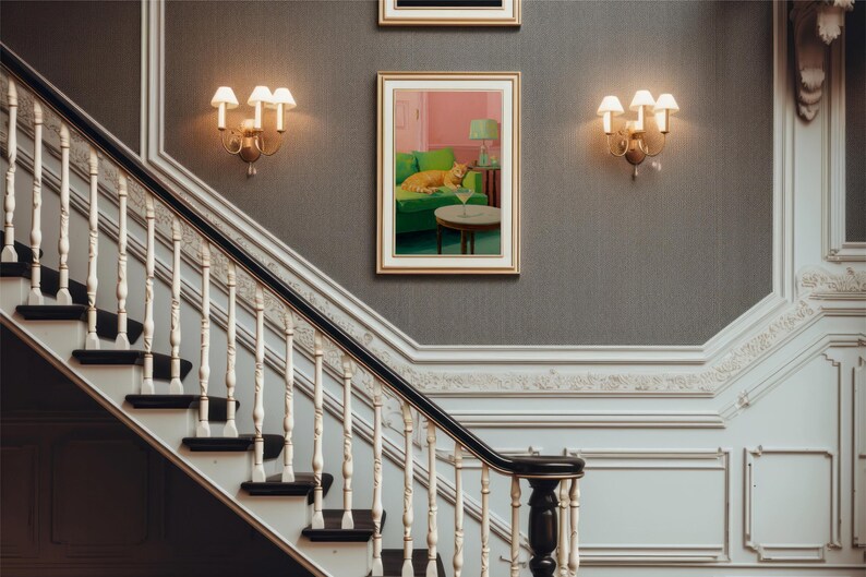 May include: A detailed interior shot featuring a staircase with a decorative balustrade and dark wood steps. The walls are grey, with sconces and framed artwork. A painting shows a cat on a green sofa with a cocktail.