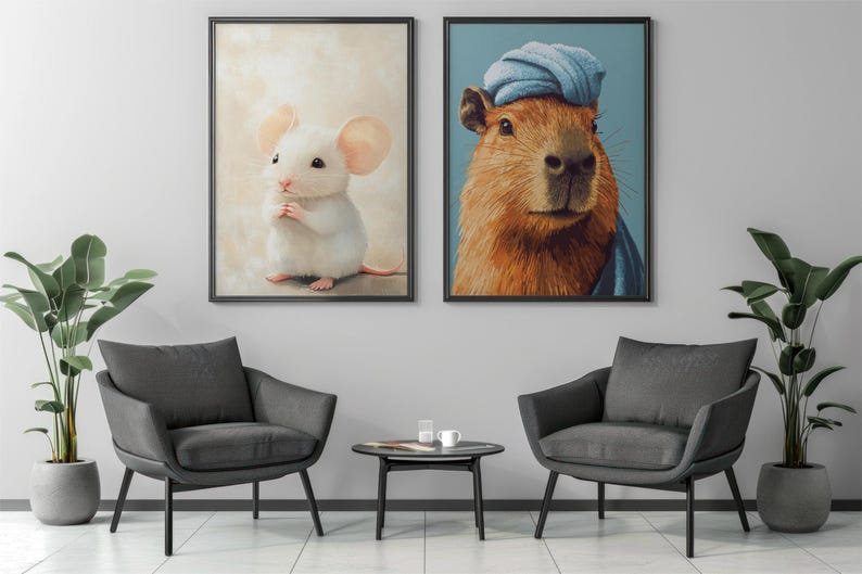 May include: Two framed art prints. One features a white mouse with pink ears and a pink tail. The other depicts a capybara wearing a blue turban. The prints are displayed above two gray armchairs.
