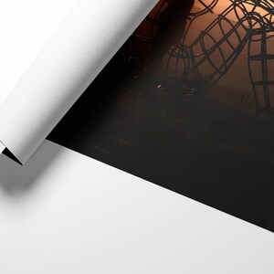 May include: A large metal sculpture of a person sitting with their head down, silhouetted against a sunset.