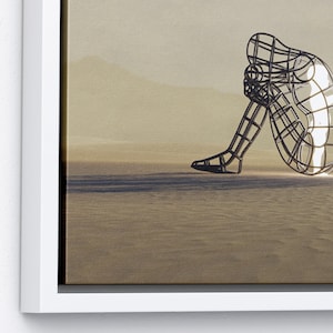 May include: A wireframe sculpture of a person sitting with their knees drawn up to their chest. The sculpture is in a desert-like setting with a light brown background.