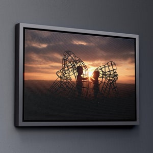 May include: Silhouette of two children standing inside a large metal sculpture against a sunset sky.