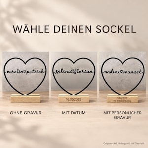 May include: Three black heart-shaped wire frames with names connected by a small heart in the center. Each heart is mounted on a rectangular wooden base. The bases show options for no engraving, a date, or a personalized engraving with text.