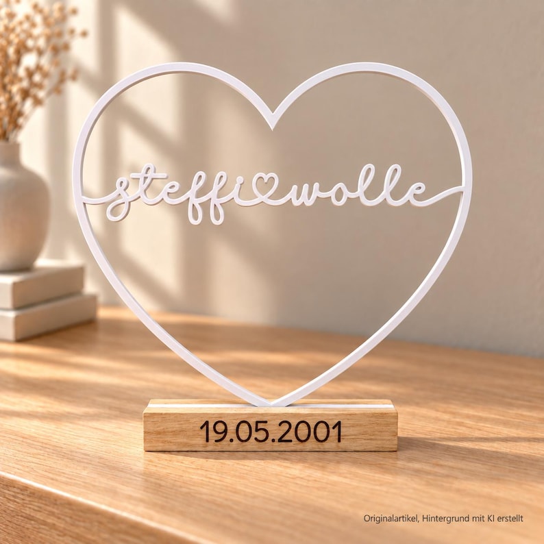 May include: A white heart-shaped frame featuring the cursive text steffi wolle with a small heart in the center. The frame is mounted on a rectangular wooden base with the date 19.05.2001 printed in black on the front of the wood.