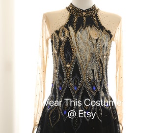 May include: Black figure skating costume with long sleeves and a black tulle skirt. The bodice is embellished with gold and silver sequins, rhinestones, and blue gems. The text "Wear This Costume @ Etsy" is visible on the skirt.