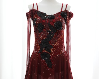 Peut inclure: Une robe de patinage artistique de couleur bordeaux à manches longues et un motif floral noir. La robe est ornée de strass et possède une superposition transparente. La robe est sur un mannequin blanc. "Wear This Costume @Etsy" est écrit en bas de la robe.