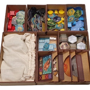 May include: Wooden organiser insert for the board game "Aeon's End". The insert has compartments for various game components, including tiles, tokens, cards, and a bag for small pieces.