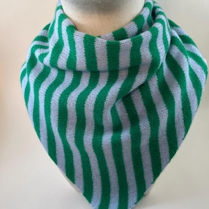May include: A green and pale blue striped knitted scarf. The scarf is displayed on a mannequin head. The scarf is made of a soft, knitted material and features vertical stripes of green and pale blue. The scarf is folded in a triangle shape.