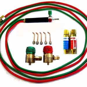 May include: A set of welding equipment with two red and green regulators, a black torch, five welding tips, and two hoses, one red and one green.
