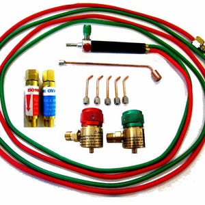 May include: A set of miniature welding equipment with red and green hoses, two small tanks, a torch, and five different sized tips. The tanks are labeled "ISO 9001" and "Oxygen".
