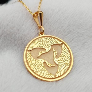 a gold necklace with a horse on it