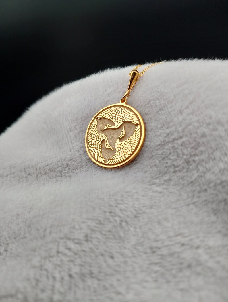 a close up of a gold pendant on a person's head