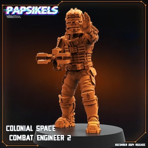 May include: A detailed, orange-toned figurine of a Colonial Space Combat Engineer 2, posed with a weapon and hand raised. The figure is on a black base, with the text "COLONIAL SPACE COMBAT ENGINEER 2" and "DECEMBER 2024 RELEASE". The logo "Papsikels" is at the top.