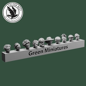 May include: A collection of miniature sculpted heads in various styles, displayed on a gray rectangular base. The text "Green Miniatures" is printed on the base. The background is a solid dark green. A circular logo with a bird is in the upper left corner.