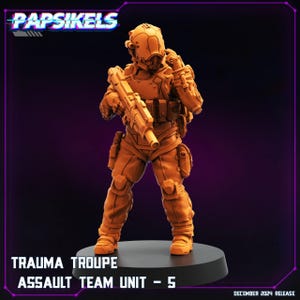 May include: An orange-toned miniature figure of a futuristic soldier, part of the Trauma Troupe Assault Team Unit - 5. The figure is fully armored, holding a rifle, and standing on a black base. The image includes the "Papsikels" logo and "December 2024 Release" text.