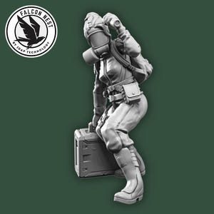 May include: A grayscale figurine of a person in a futuristic outfit, including a helmet, backpack, and boots, leaning on a box. The figure is set against a dark green background, with a circular logo in the upper left corner that reads "FALCON NEST by TRAP TECHNOLOGY."