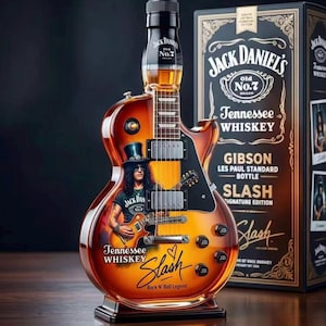 May include: A Jack Daniel's Tennessee Whiskey bottle shaped like a Gibson Les Paul guitar. The amber glass features a graphic of Slash, the text Tennessee Whiskey, and a Slash signature. The bottle includes a black cap and four control knobs.