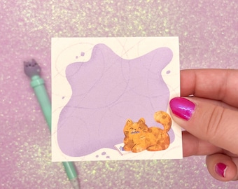 May include: A purple and white sticker with a cartoon orange cat holding a purple flower. The cat is smiling and has a pink nose. The sticker is on a pink sparkly background.