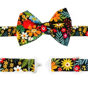 May include: A black bow tie with a colorful floral pattern. The bow tie is made of fabric and has a matching adjustable strap.