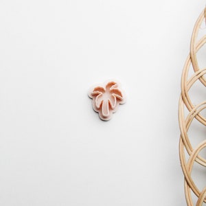 May include: A pink plastic palm tree cookie cutter.