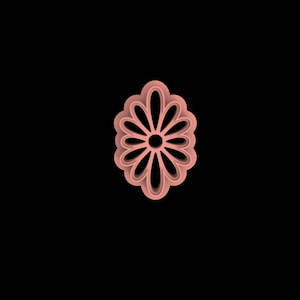 May include: A light pink, flower-shaped cookie cutter with a detailed petal design. The cutter has a central circular hole and is set against a black background. The design is symmetrical and suitable for baking.