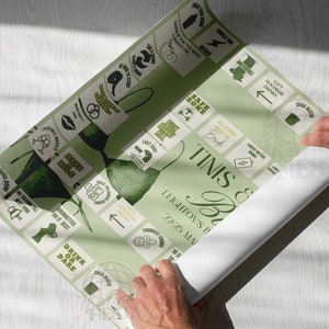 May include: A green and white game board with the text "Tinis & Bricks" and "Leighton's Birthday 22:25 MA". The board has a variety of squares with different instructions, such as "Drink or Dare", "Name a Rule", and "Most Interesting Story".