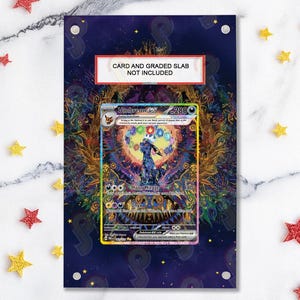 May include: A framed artwork featuring a Pokémon card with an Umbreon design. The card is set against a colorful, detailed background with gold and blue accents. The text "CARD AND GRADED SLAB NOT INCLUDED" is visible.