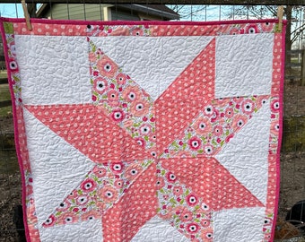 100%cotton Eight pointed star quilt. Perfect for a baby shower gift, nursery decor or birthday gift. Hand sewn binding accents the border