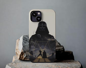 May include: A phone case featuring a black silhouette of Darth Vader with a scene of a lightsaber battle. The case has a cream-colored background and is displayed on a stone surface.