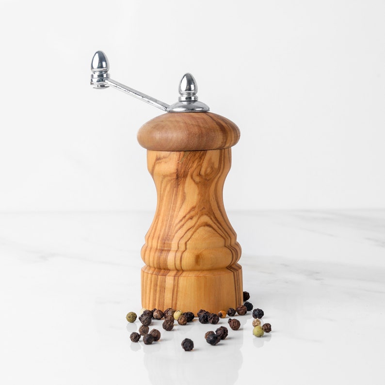 Elegant Wooden Pepper Grinder crafted from Mediterranean olive wood, featuring a simple twist-handle design for everyday culinary use.