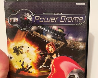 May include: PlayStation 2 game case for Power Drome, a racing game with a red and black futuristic vehicle on the cover. The game is rated T for Teen by the ESRB.