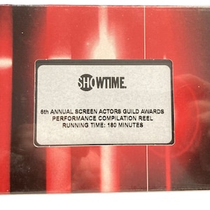May include: A silver label with the text "SHOWTIME." and "6th ANNUAL SCREEN ACTORS GUILD AWARDS PERFORMANCE COMPILATION REEL RUNNING TIME: 180 MINUTES". The label is on a red and black background.