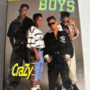 May include: Cassette single for "The Boys" featuring a group of four young men. The cover has the word "Crazy" in yellow and the band's name in blue and yellow. The men are wearing various outfits, including jackets, jeans, and sunglasses.