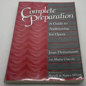 May include: A red book titled "Complete Preparation: A Guide to Auditioning for Opera" by Joan Dornemann with Maria Ciaccia. Introduction by Sherrill & Nancy Milnes.