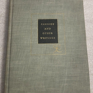 May include: A green book with the title "CANDIDE AND OTHER WRITINGS" in a black box on the front cover.