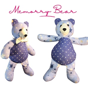 May include: Two plush teddy bears with blue and white star patterns. One bear has a white bow tie. The bears have a dark blue body and light blue limbs. The text "Memory Bear" is written above the bears in pink cursive.