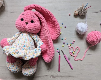 Enchanting Pink Bunny: Crochet-Crafted, Long-Eared Charm – the Perfect Gift for Joy and Coziness! Cute pink rabbi with long ears in a dress.