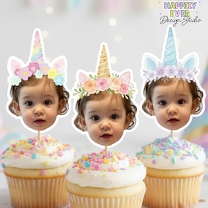 May include: Three cupcakes with a child's face as a topper, each wearing a unicorn horn and floral headband. The cupcakes have white icing and colourful sprinkles. The image includes the text "Happily Ever Design Studio".