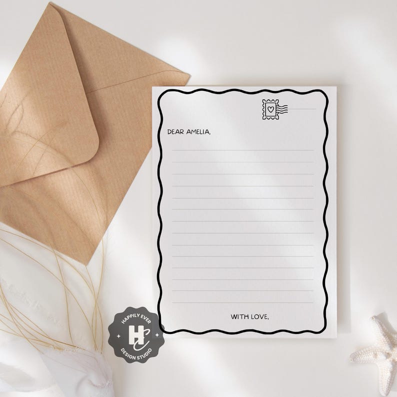 May include: A white lined notepad with a black wavy border, a postage stamp graphic, and the text "Dear Amelia, With Love,". A brown envelope is in the background. The notepad is from Happily Ever Design Studio.