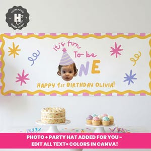 May include: A birthday banner with the text "It's fun to be ONE" and "Happy 1st Birthday Olivia!" in yellow and purple. The banner has a photo of a baby wearing a party hat. The banner is decorated with stars and swirls.