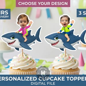 May include: Two personalized cupcake toppers featuring a cartoon shark with a child's face mounted on a wooden stick. One child wears a pink and lime green swimsuit, the other a lime green and blue swimsuit. Text includes CHOOSE YOUR DESIGN, 24 HRS MAX DELIVERY, 3 SIZES!, and PERSONALIZED CUPCAKE TOPPERS DIGITAL FILE.