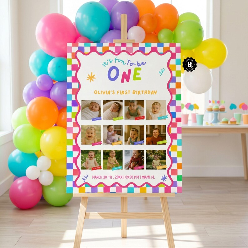 May include: A rectangular birthday sign on a wooden easel featuring a colorful checkered border, twelve photos of a baby, and the text It's fun to be ONE, Olivia's First Birthday, and March 30th, 20XX, 09:30 P.M., Miami, FL, surrounded by a balloon arch.