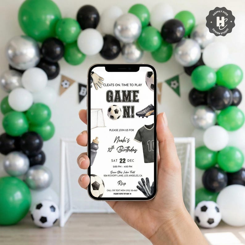 May include: A smartphone displays a soccer-themed birthday invitation with the text "Game On!" and details for Noah's 10th birthday. The background features a balloon arch in green, black, white, and silver, with soccer balls.