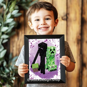 May include: A framed print featuring pixelated characters from the Minecraft game. The print showcases an Enderman, a green Creeper, and a block of dirt against a purple splatter background. The frame is black, and the image is held by a person.