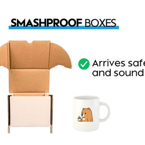 May include: A brown cardboard box with a white interior and a checkmark next to the text "Arrives safe and sound". A white ceramic mug with a brown bear illustration is shown in front of the box.