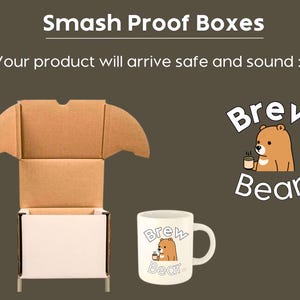 May include: An open cardboard shipping box with a white exterior and brown interior, positioned next to a white ceramic mug featuring a cartoon bear holding a cup and the text Brew Bear co. The image includes the text Smash Proof Boxes.